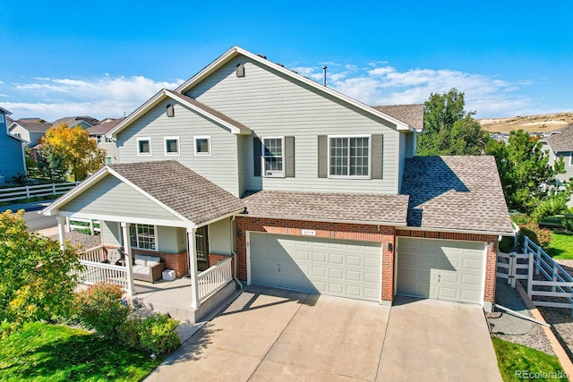 3779 Aspen Hollow Ct, Castle Rock, CO 80104 - view of front facade with roof with shingles, covered porch, brick siding, and concrete driveway