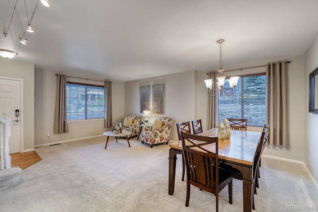 3779 Aspen Hollow Ct, Castle Rock, CO 80104 - carpeted dining area featuring a chandelier, baseboards, and track lighting