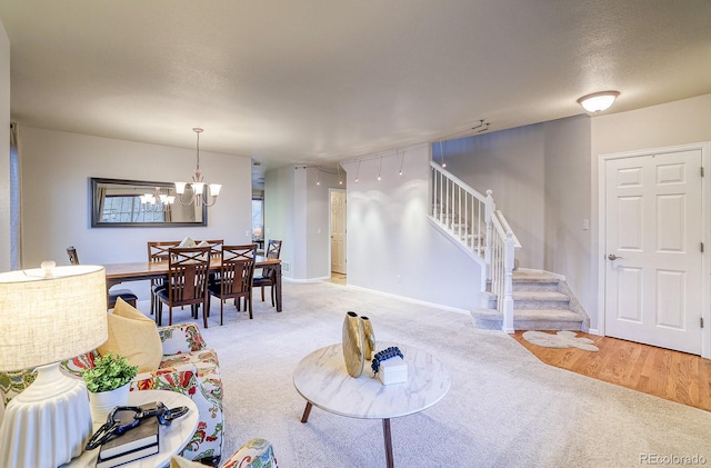 3779 Aspen Hollow Ct, Castle Rock, CO 80104 - living room with stairway, light colored carpet, a chandelier, and baseboards