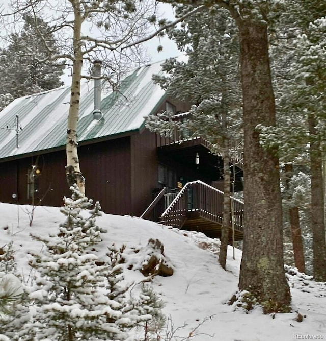 snow covered property featuring a deck