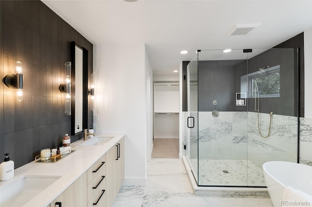 bathroom featuring double vanity, a stall shower, visible vents, marble finish floor, and a sink