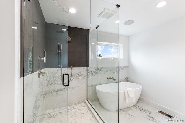 full bath featuring marble finish floor, visible vents, a freestanding bath, a shower stall, and baseboards