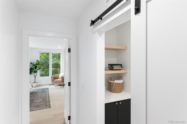 interior space featuring light wood-style flooring and a barn door