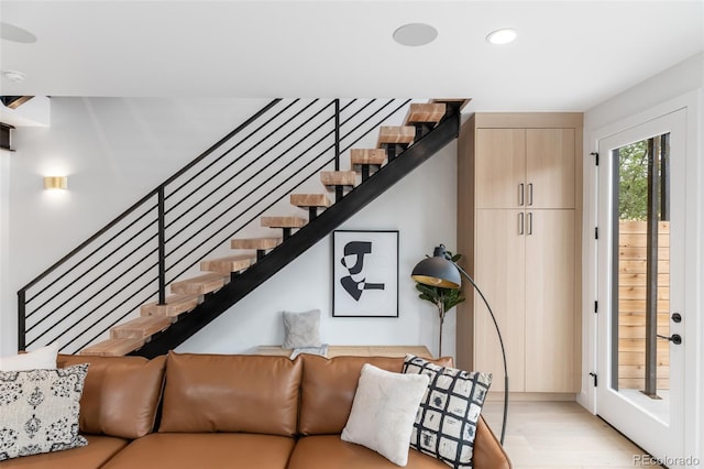 living area featuring stairway, light wood-type flooring, and recessed lighting