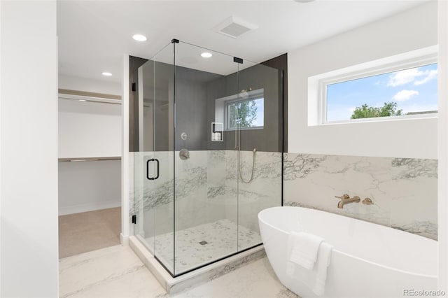 bathroom featuring marble finish floor, recessed lighting, visible vents, a freestanding bath, and a stall shower