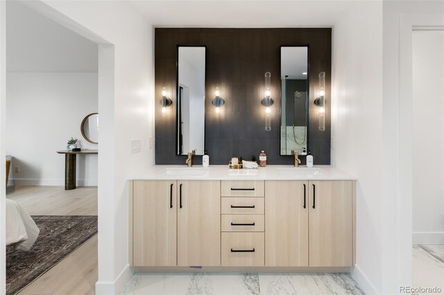 bathroom with vanity and hardwood / wood-style flooring