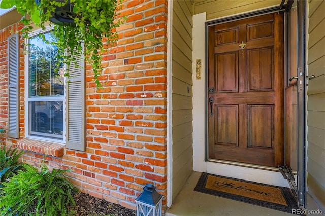 8156 Carr Cir, Arvada, CO 80005 - doorway to property featuring brick siding