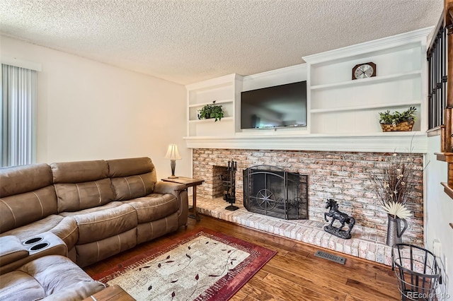 8156 Carr Cir, Arvada, CO 80005 - living room with wood-type flooring, a fireplace, and a textured ceiling