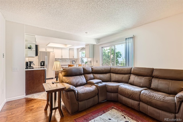 8156 Carr Cir, Arvada, CO 80005 - living room with light wood-style flooring and a textured ceiling