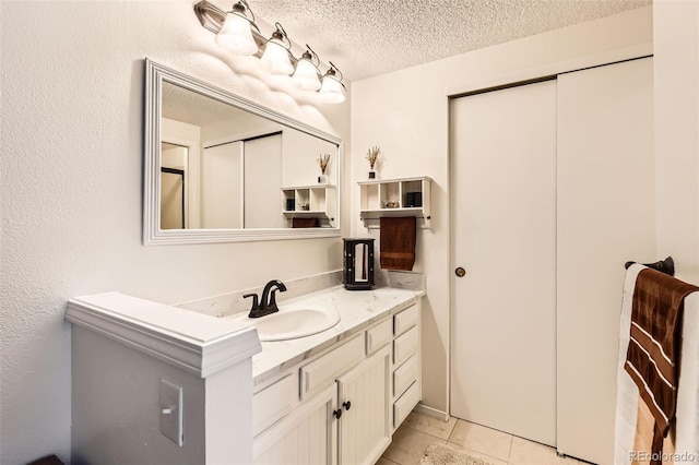 8156 Carr Cir, Arvada, CO 80005 - bathroom featuring vanity, a textured ceiling, and tile patterned floors