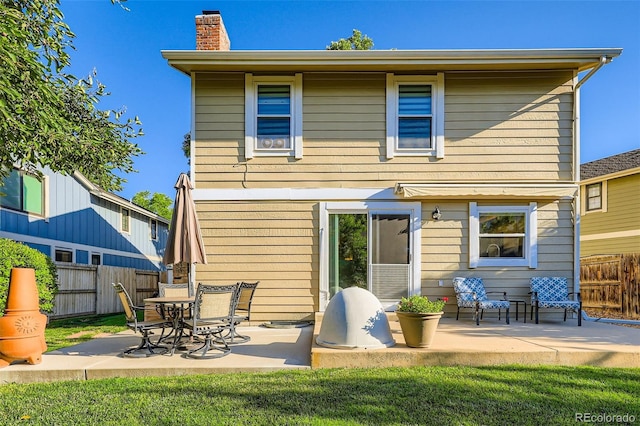 8156 Carr Cir, Arvada, CO 80005 - back of house featuring a chimney and a patio