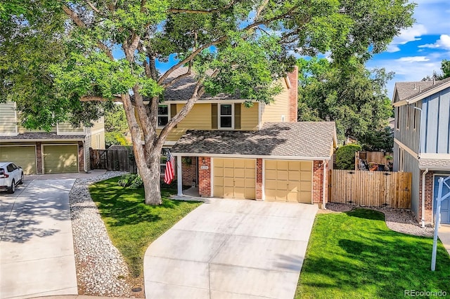 8156 Carr Cir, Arvada, CO 80005 - view of front of house featuring concrete driveway, brick siding, and an attached garage