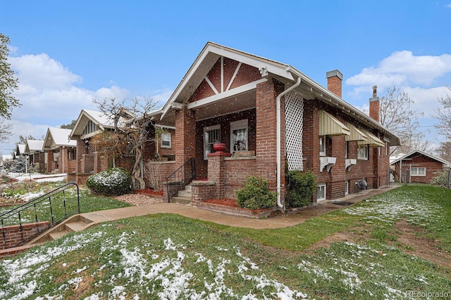 3159 36th Ave, Denver, CO 80211 - view of front facade featuring brick siding, a front yard, and a chimney