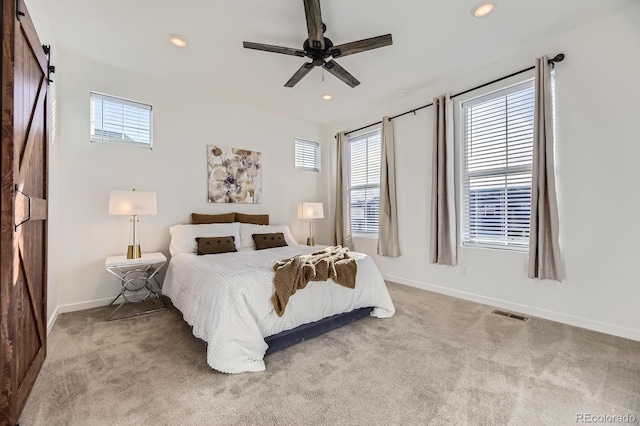bedroom with baseboards, recessed lighting, carpet floors, and multiple windows
