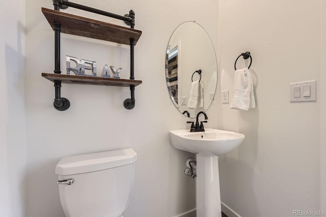 half bathroom featuring toilet
