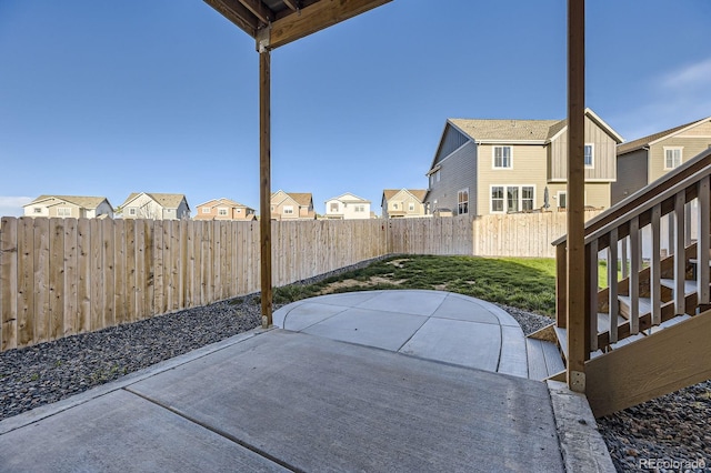 view of patio featuring a residential view and a fenced backyard