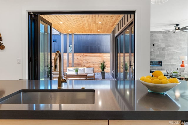 interior space featuring wood ceiling, recessed lighting, ceiling fan, and a sink