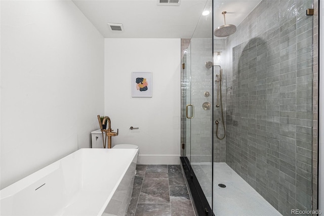 full bath with a stall shower, visible vents, a freestanding tub, and baseboards