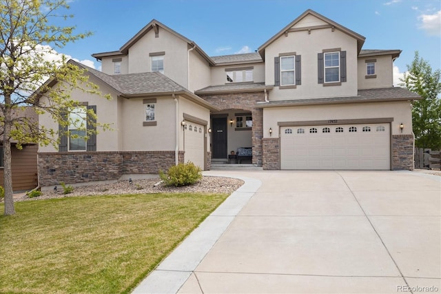 17452 W 83rd Pl, Arvada, CO 80007 - view of front facade with stucco siding, stone siding, a garage, concrete driveway, and a front lawn