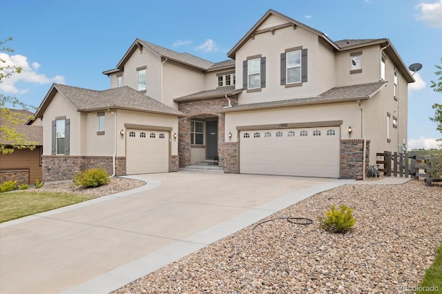 17452 W 83rd Pl, Arvada, CO 80007 - view of front of property with stucco siding, stone siding, driveway, and an attached garage