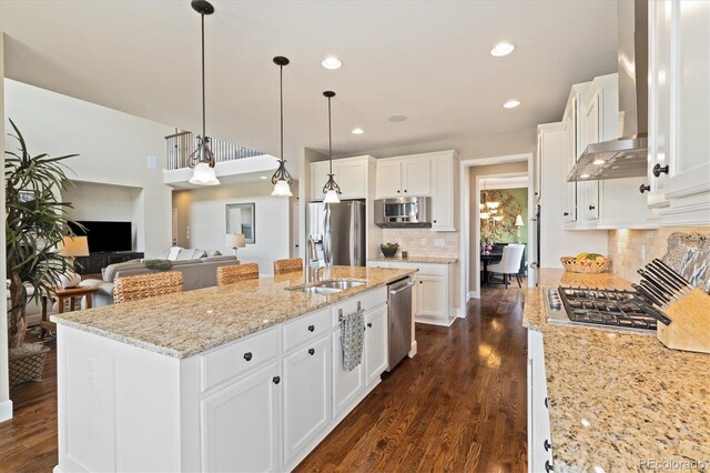 17452 W 83rd Pl, Arvada, CO 80007 - kitchen with a sink, appliances with stainless steel finishes, decorative backsplash, white cabinets, and dark wood-type flooring