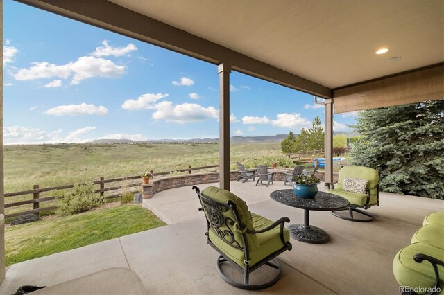 17452 W 83rd Pl, Arvada, CO 80007 - view of patio / terrace featuring fence, outdoor dining space, and a view of countryside