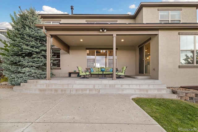 17452 W 83rd Pl, Arvada, CO 80007 - back of house featuring stucco siding, an outdoor hangout area, and a patio