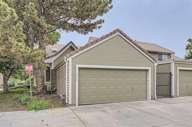 2299 Ranch Dr, Westminster, CO 80234 - view of front of property with a tiled roof, an attached garage, and concrete driveway