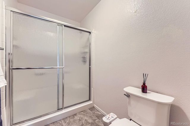 2299 Ranch Dr, Westminster, CO 80234 - full bath with a shower with shower door, toilet, and baseboards