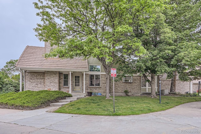 2299 Ranch Dr, Westminster, CO 80234 - view of front of house with brick siding, a front yard, and a chimney