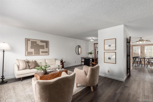 living area with a textured ceiling, wood finished floors, and baseboards