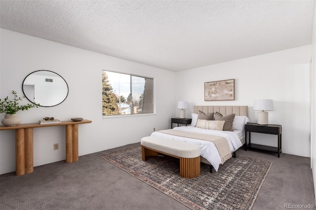 bedroom with a textured ceiling and carpet