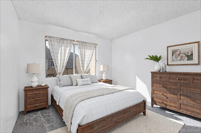 bedroom with a textured ceiling and carpet