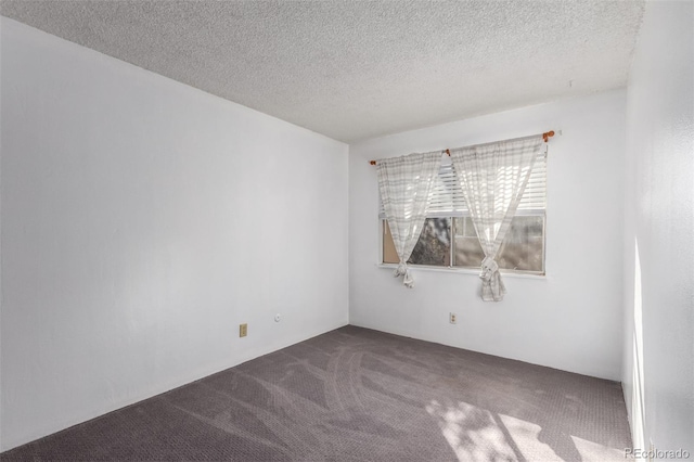 carpeted empty room with a textured ceiling