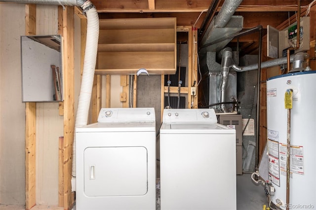 washroom with laundry area, washer and clothes dryer, and gas water heater