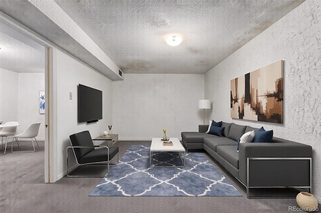 carpeted living area with a textured ceiling and a textured wall