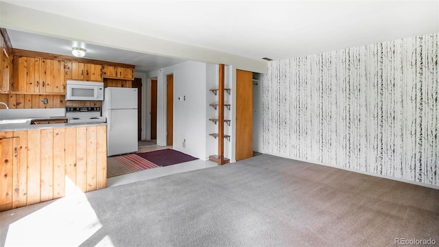 28958 Buffalo Park Rd, Evergreen, CO 80439 - kitchen with white appliances, wallpapered walls, light colored carpet, and light countertops