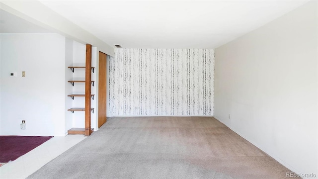 28958 Buffalo Park Rd, Evergreen, CO 80439 - unfurnished room featuring carpet floors, an accent wall, and wallpapered walls