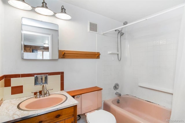 28958 Buffalo Park Rd, Evergreen, CO 80439 - bathroom with vanity, shower / tub combination, and decorative backsplash