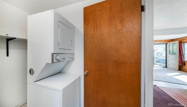 28958 Buffalo Park Rd, Evergreen, CO 80439 - laundry area with stacked washer / dryer and carpet flooring