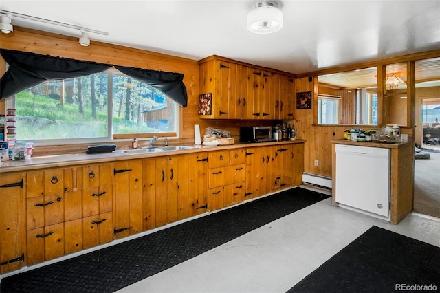 28958 Buffalo Park Rd, Evergreen, CO 80439 - kitchen featuring dishwasher, a baseboard radiator, light flooring, light countertops, and brown cabinets