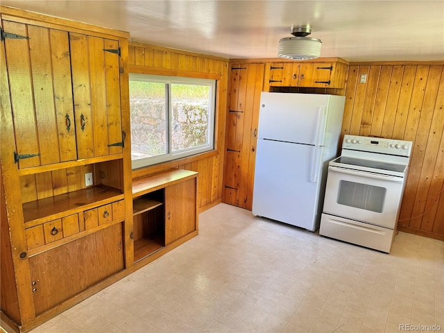 28958 Buffalo Park Rd, Evergreen, CO 80439 - kitchen with white appliances, wood walls, light floors, and brown cabinetry