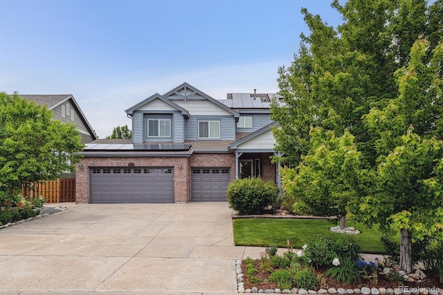 26155 E Euclid Dr, Aurora, CO 80016 - view of front facade with solar panels, brick siding, concrete driveway, and a garage