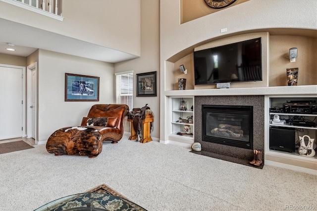 26155 E Euclid Dr, Aurora, CO 80016 - living area featuring carpet floors, built in features, and a fireplace with flush hearth