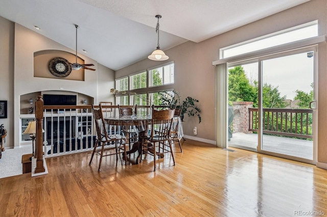 26155 E Euclid Dr, Aurora, CO 80016 - dining room featuring a fireplace, wood finished floors, and high vaulted ceiling