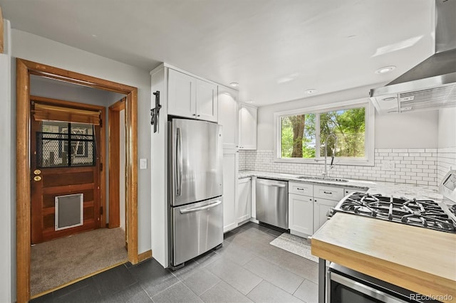 5355 S Windermere St, Littleton, CO 80120 - kitchen with stainless steel appliances, a sink, white cabinets, island range hood, and recessed lighting