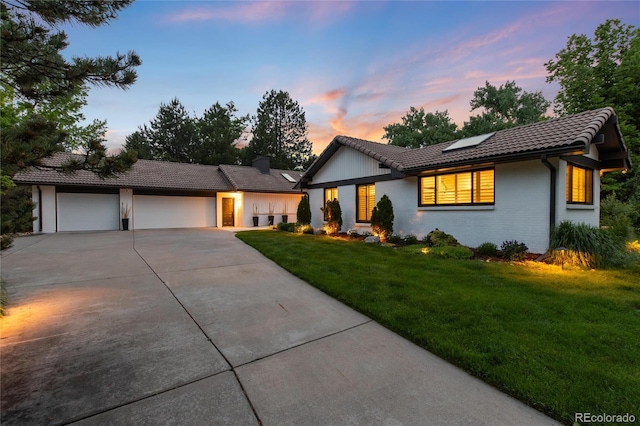 1 Club Ln, Littleton, CO 80123 - single story home featuring driveway, a tiled roof, a garage, roof mounted solar panels, and a front lawn