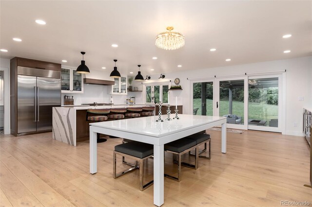 1 Club Ln, Littleton, CO 80123 - kitchen featuring built in refrigerator, a center island, recessed lighting, light countertops, and light wood finished floors