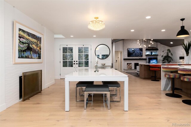 1 Club Ln, Littleton, CO 80123 - dining space featuring a chandelier, a fireplace, light wood-style flooring, and recessed lighting