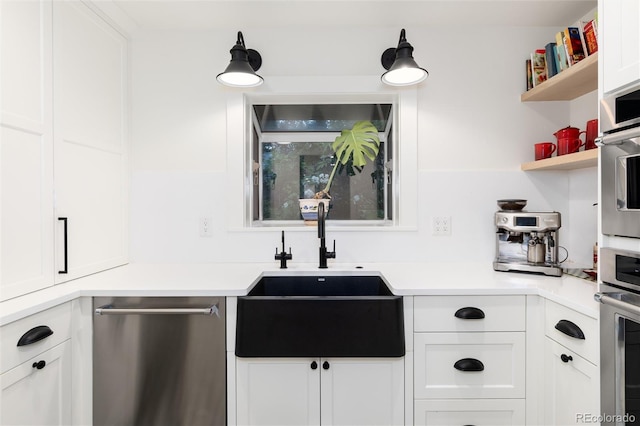 1 Club Ln, Littleton, CO 80123 - kitchen with stainless steel appliances, open shelves, white cabinetry, and light countertops